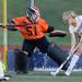 Saline's Chrissy Hays helps out her goalkeeper Claire Koerschner by blocking a shot on goal during the first half against Huron at Saline on Thursday night. Melanie Maxwell I AnnArbor.com